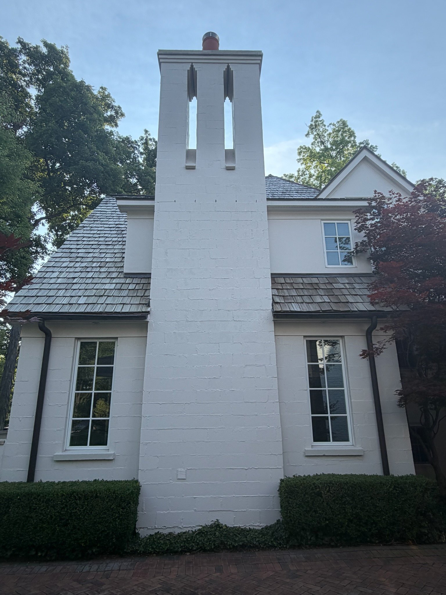 Tall white painted brick chimney on luxury Rochester Hills home — Grey Oaks Chimney